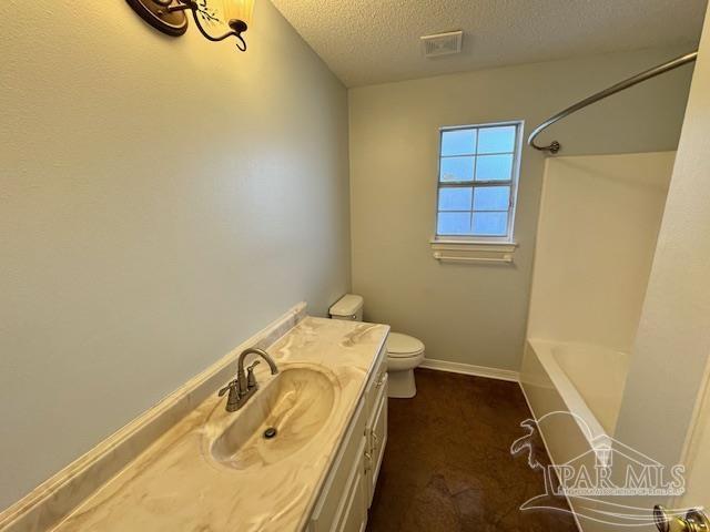 full bathroom featuring vanity, toilet, a textured ceiling, and shower / washtub combination