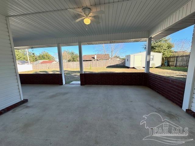 view of patio / terrace featuring ceiling fan and a storage shed