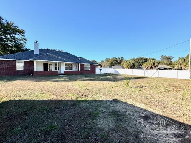 back of house with a yard and a porch