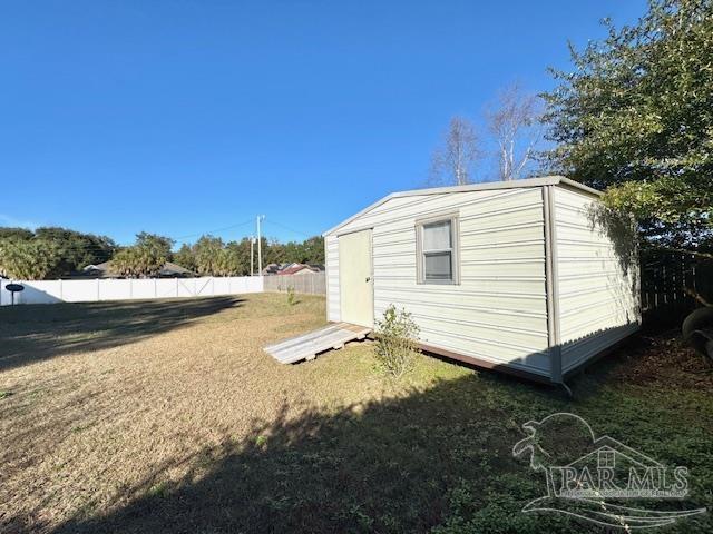 view of shed with fence