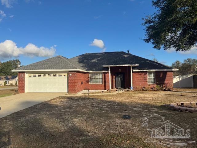 ranch-style house with brick siding, driveway, and a garage