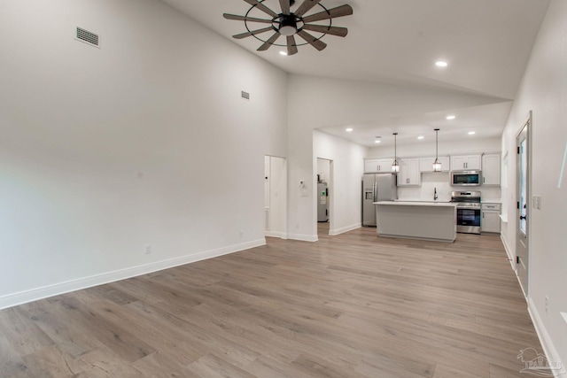 unfurnished living room with visible vents, baseboards, ceiling fan, light wood-type flooring, and recessed lighting