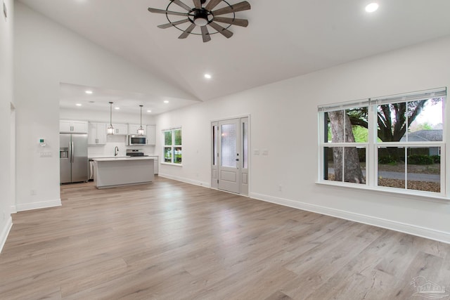 unfurnished living room featuring recessed lighting, light wood-style flooring, baseboards, and ceiling fan