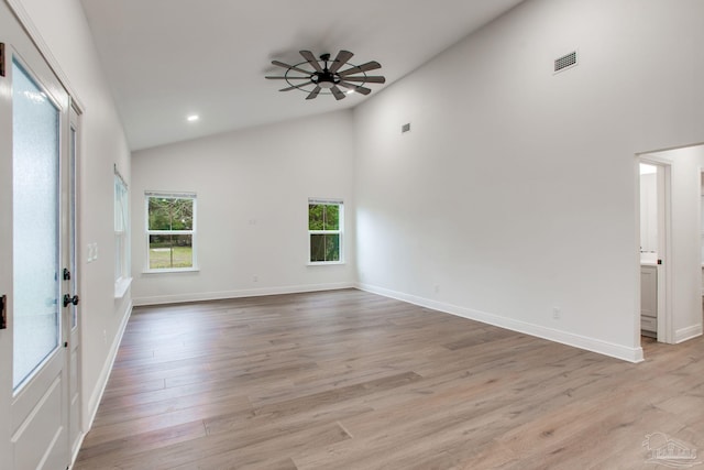 unfurnished room with visible vents, light wood-style flooring, a ceiling fan, and baseboards