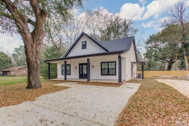 modern farmhouse style home with board and batten siding, concrete driveway, and covered porch