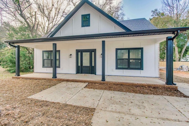 view of front of property with a porch and roof with shingles