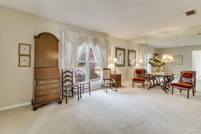 sitting room featuring carpet floors, baseboards, and visible vents