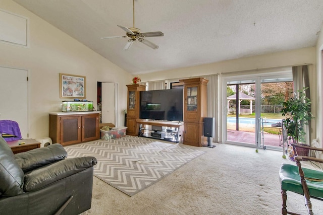 living room featuring ceiling fan, high vaulted ceiling, a textured ceiling, and light colored carpet