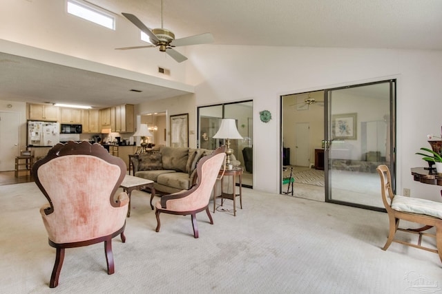 living room featuring light carpet, ceiling fan, visible vents, and high vaulted ceiling