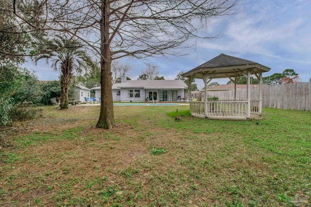 view of yard featuring a gazebo, fence, and a pool