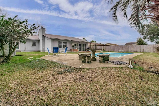 view of swimming pool featuring a yard, a patio area, fence, and a fenced in pool