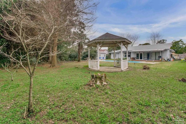 view of yard featuring a patio area and an outdoor pool