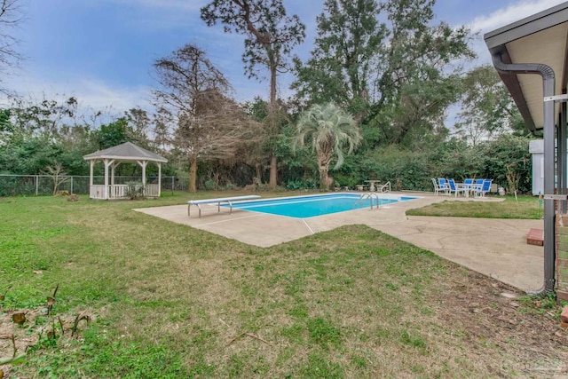 view of swimming pool featuring a fenced in pool, a lawn, a gazebo, a patio area, and a diving board