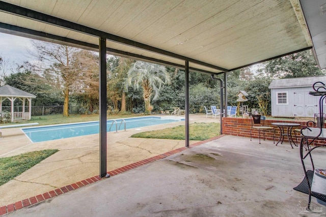 outdoor pool with fence, an outdoor structure, a patio, and a gazebo