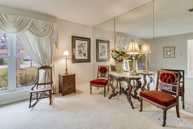 sitting room featuring carpet flooring, visible vents, and baseboards