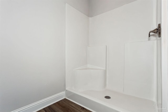 bathroom featuring hardwood / wood-style floors and a shower