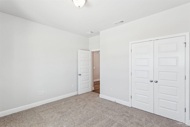 unfurnished bedroom with carpet floors and a closet