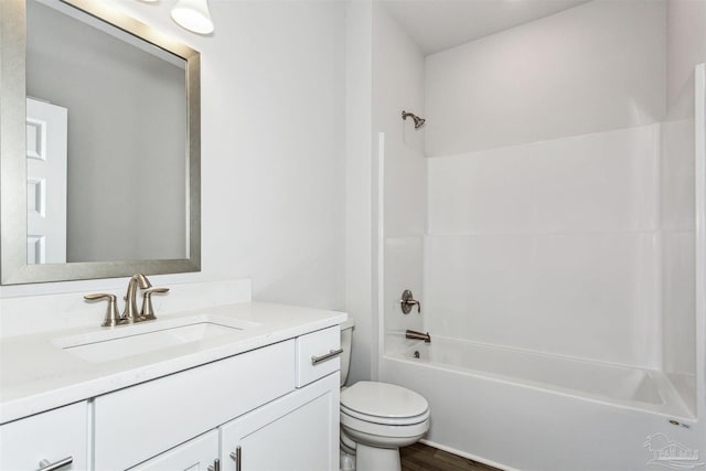 full bathroom with vanity, tub / shower combination, wood-type flooring, and toilet