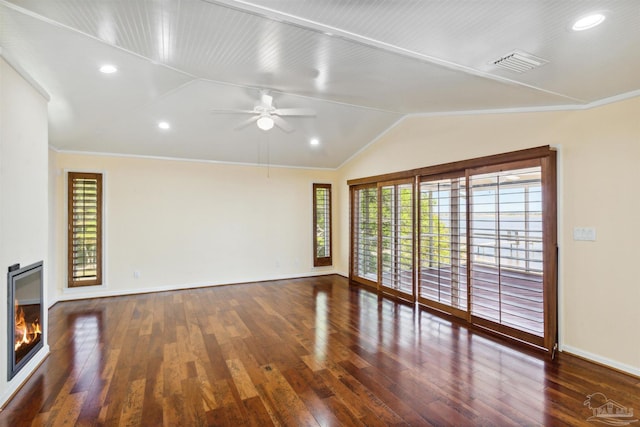 unfurnished living room featuring lofted ceiling, dark wood-type flooring, ornamental molding, and ceiling fan