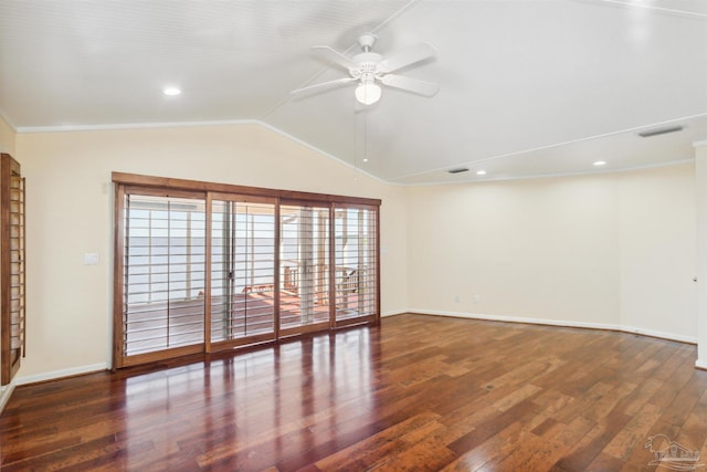 spare room featuring lofted ceiling, dark hardwood / wood-style flooring, and ceiling fan