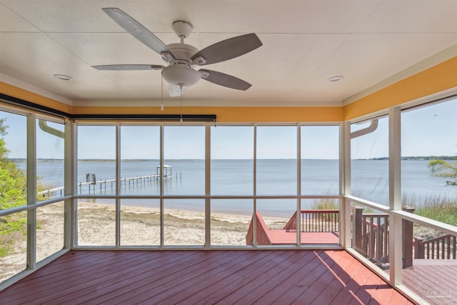 unfurnished sunroom with a water view and ceiling fan