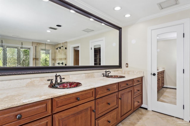 bathroom with vanity, crown molding, and walk in shower