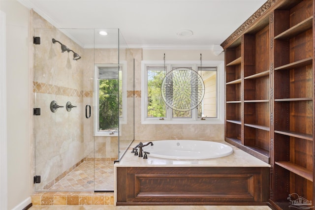 bathroom with ornamental molding and separate shower and tub