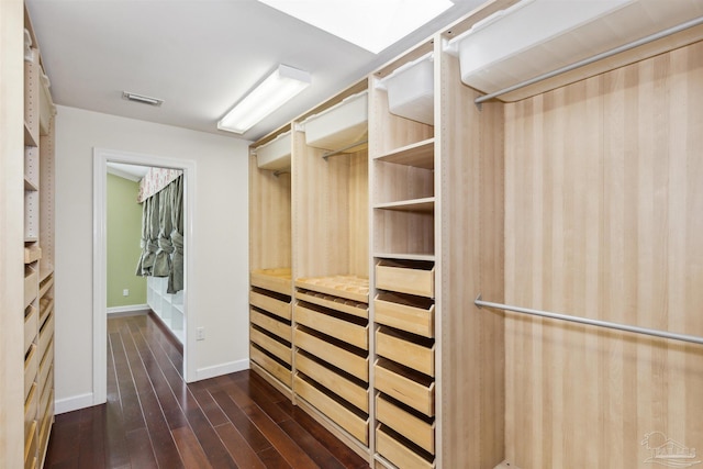 walk in closet featuring dark wood-type flooring