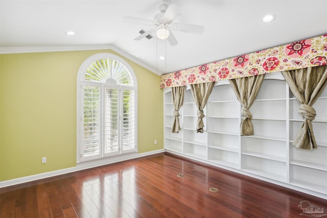 empty room featuring dark wood-type flooring, ceiling fan, lofted ceiling, and crown molding