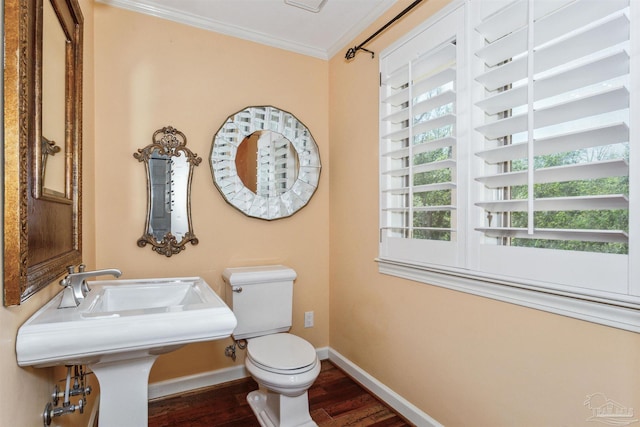 bathroom featuring hardwood / wood-style floors, ornamental molding, and toilet