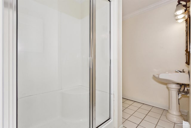 bathroom with a shower with door, crown molding, and tile patterned flooring