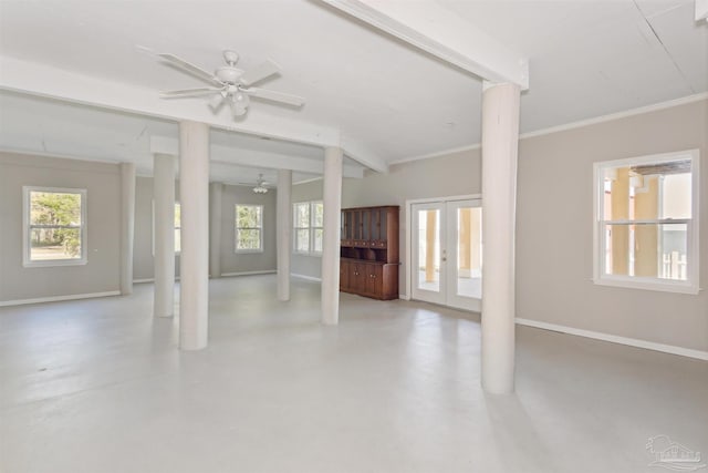 unfurnished living room with decorative columns, concrete floors, ceiling fan, and french doors