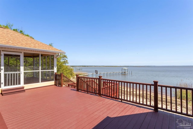 wooden terrace with a water view and a sunroom