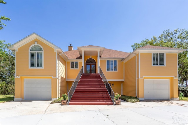 view of front of property with a garage and french doors