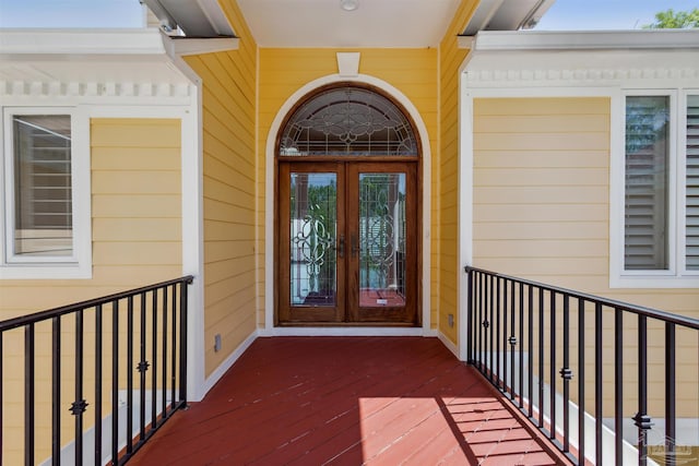 property entrance featuring a balcony and french doors