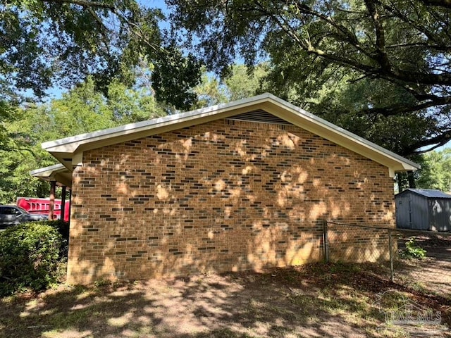 view of side of property with a storage shed