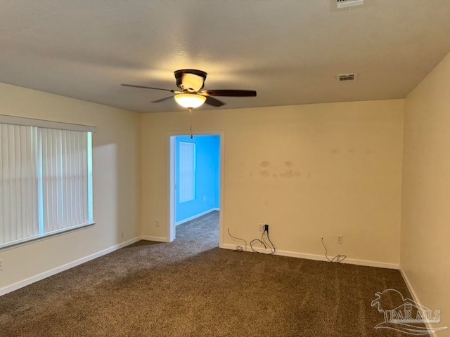 spare room with ceiling fan and carpet floors