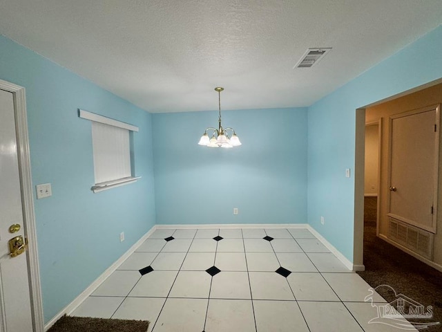 unfurnished dining area featuring light tile patterned floors, a chandelier, and a textured ceiling