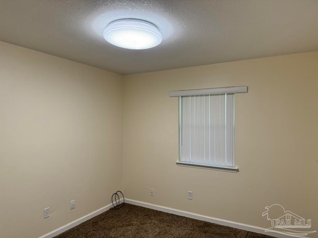 carpeted empty room with a textured ceiling