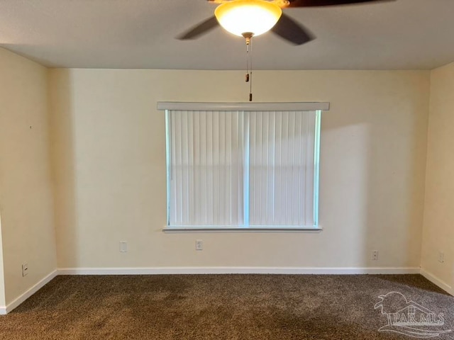 carpeted spare room with ceiling fan