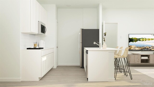 6377 Buckthorn Cir Lot 14E, Pace, FL 32571 - kitchen with a breakfast bar area, light wood-style floors, white cabinets, and light countertops