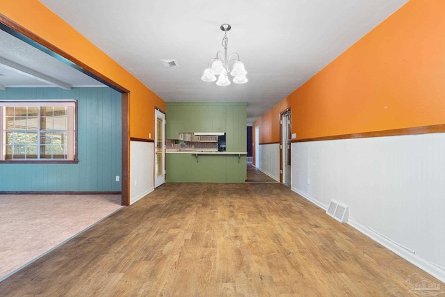 interior space featuring light hardwood / wood-style flooring and a notable chandelier