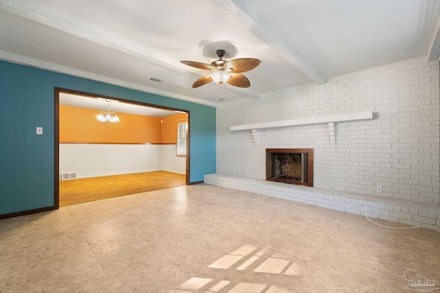 unfurnished living room featuring beam ceiling, a fireplace, ceiling fan with notable chandelier, and ornamental molding