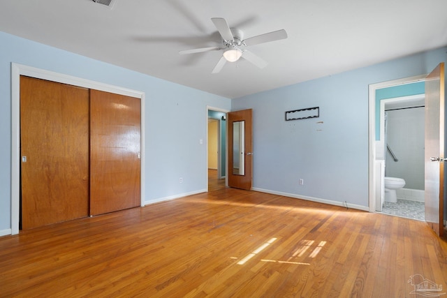 unfurnished bedroom with hardwood / wood-style floors, ensuite bathroom, a closet, and ceiling fan