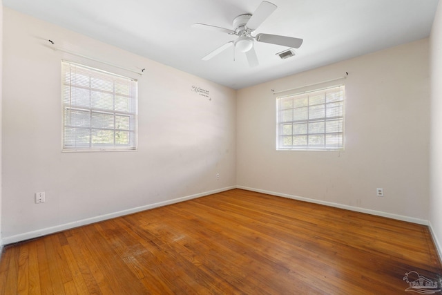 unfurnished room with hardwood / wood-style flooring and ceiling fan