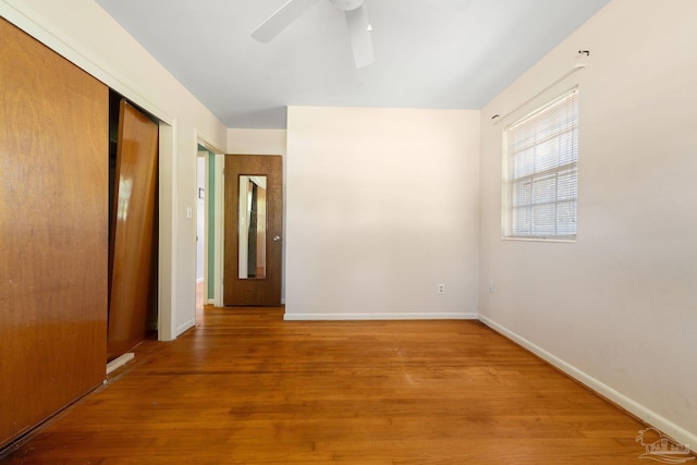 spare room featuring hardwood / wood-style floors and ceiling fan