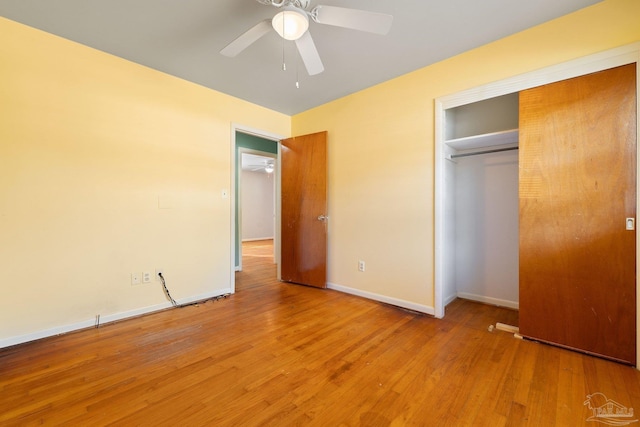 unfurnished bedroom featuring a closet, light hardwood / wood-style flooring, and ceiling fan