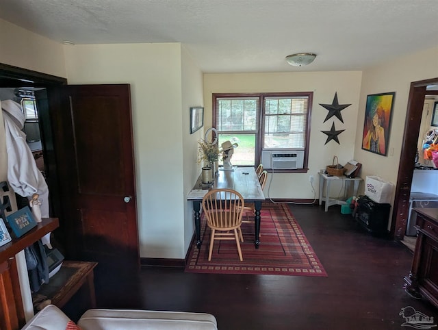 interior space with cooling unit, dark wood-style floors, and a textured ceiling