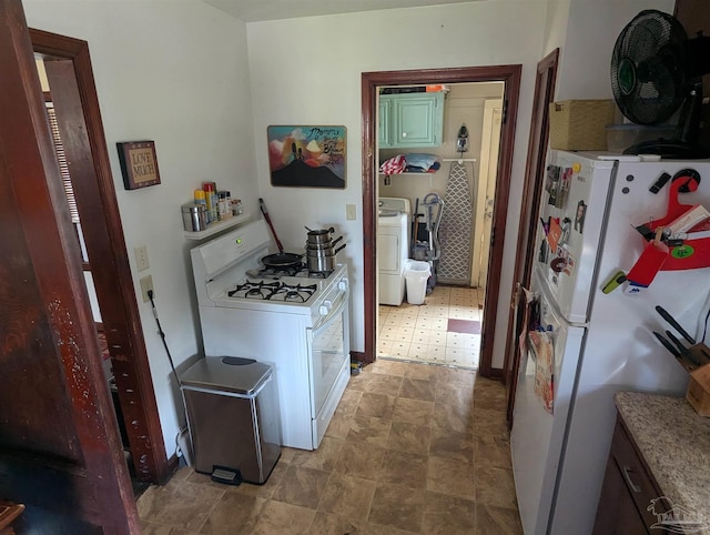 kitchen featuring light floors, white appliances, washer / clothes dryer, and light countertops