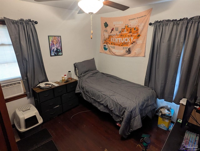 bedroom with cooling unit, ceiling fan, and dark wood-style flooring